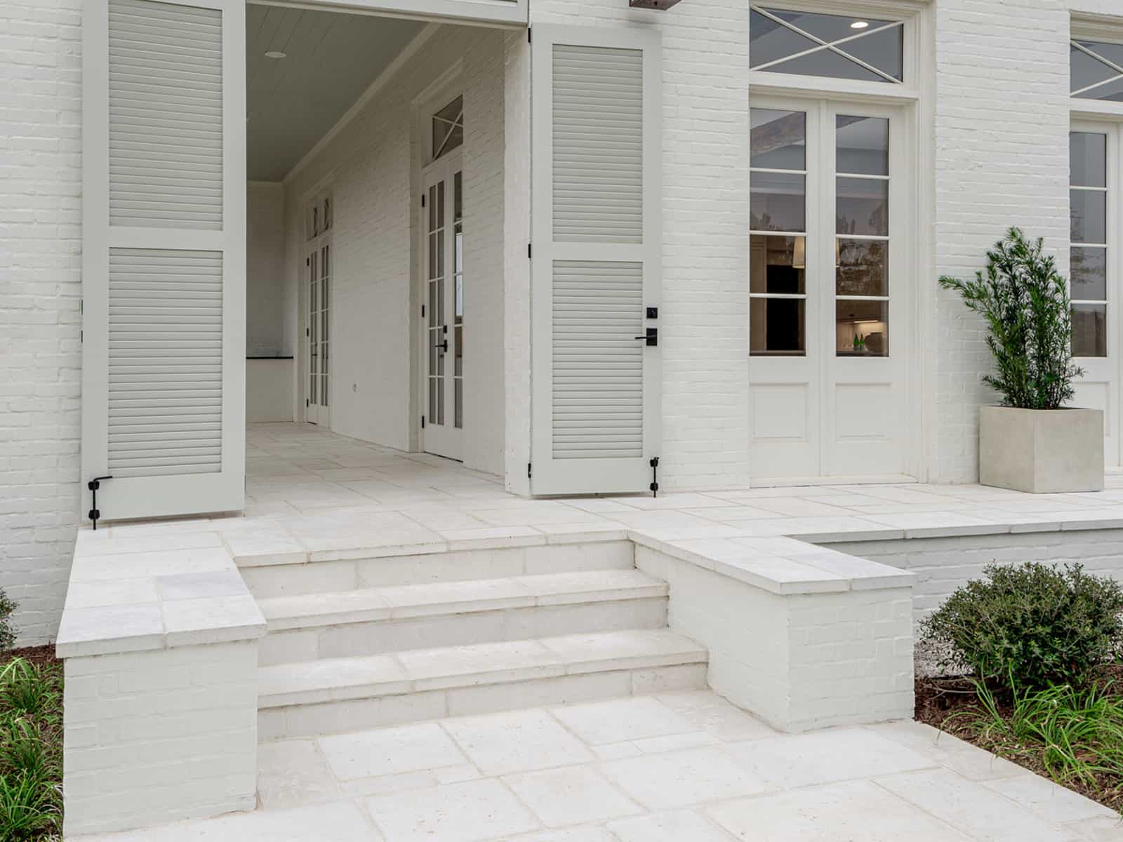 Layered Front Door Mats on Concrete Pavers - Transitional - Porch